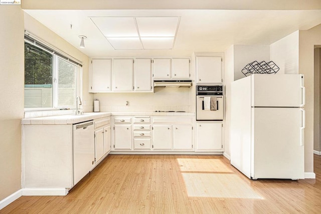 kitchen with tile countertops, sink, white appliances, white cabinetry, and light hardwood / wood-style flooring