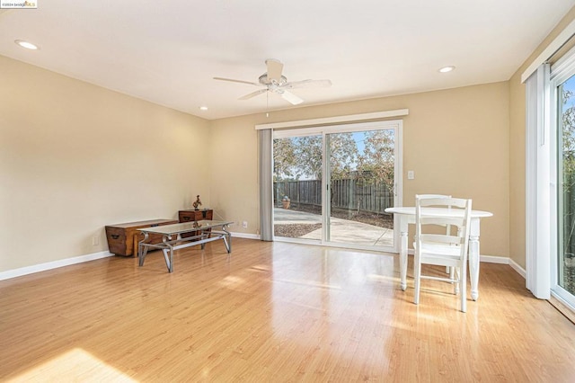 dining space with ceiling fan and light hardwood / wood-style floors