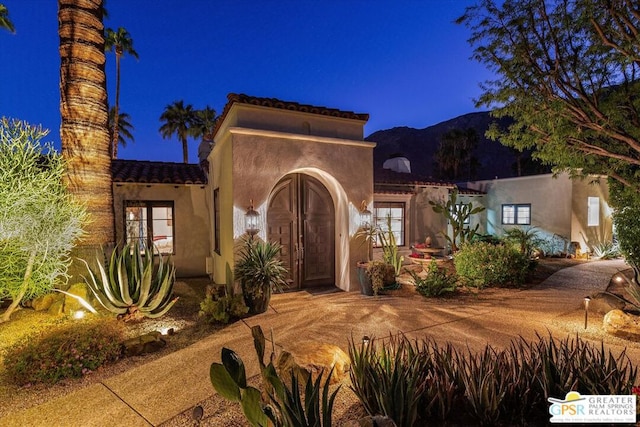 mediterranean / spanish house featuring a mountain view