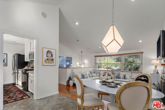 dining space featuring light hardwood / wood-style flooring and high vaulted ceiling