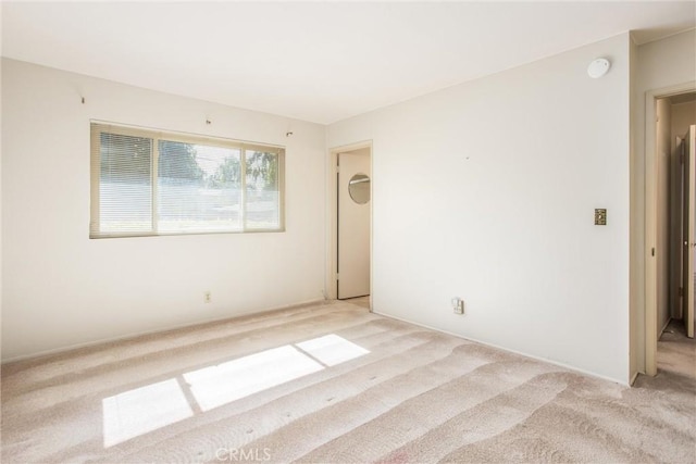 spare room with light colored carpet