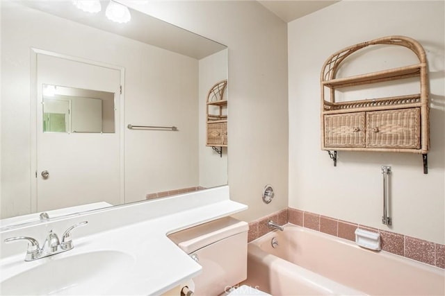 bathroom with a tub, sink, and toilet