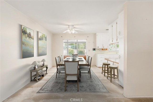 carpeted dining area featuring ceiling fan