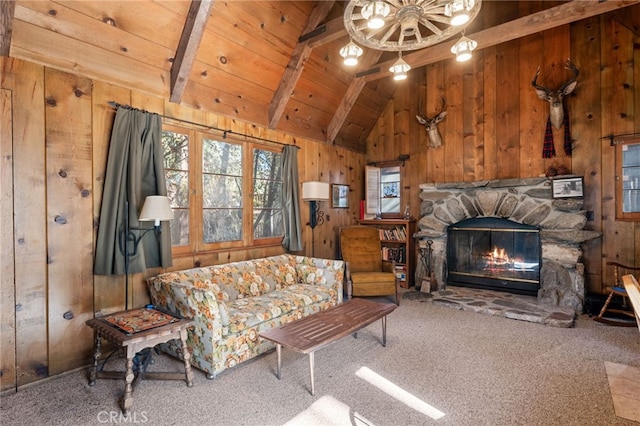 carpeted living room featuring lofted ceiling with beams, a stone fireplace, wood ceiling, and wooden walls