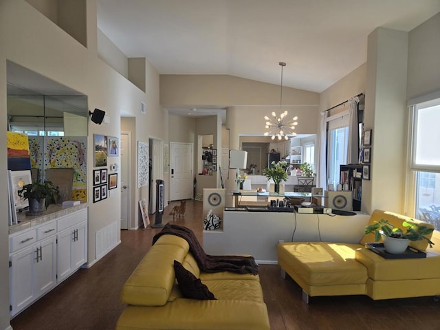 living room featuring an inviting chandelier, dark wood-type flooring, and vaulted ceiling