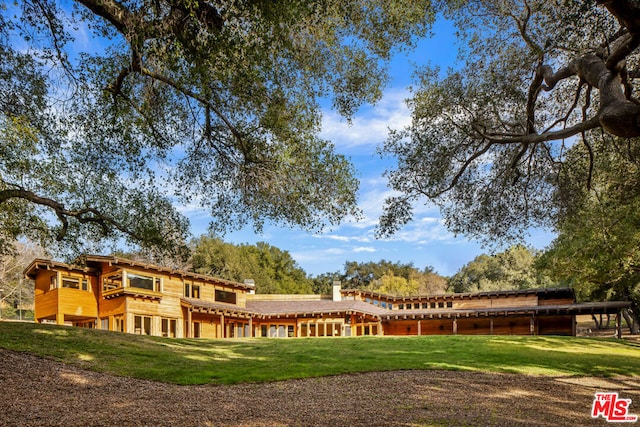 rear view of house with a yard