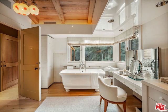 bathroom with beamed ceiling, hardwood / wood-style floors, a tub, and wood ceiling