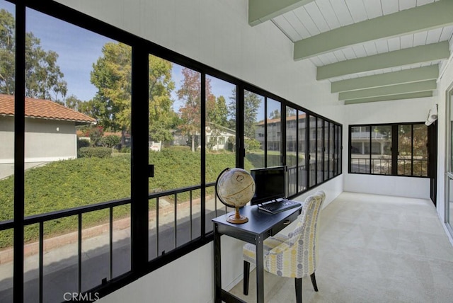 sunroom / solarium featuring beam ceiling