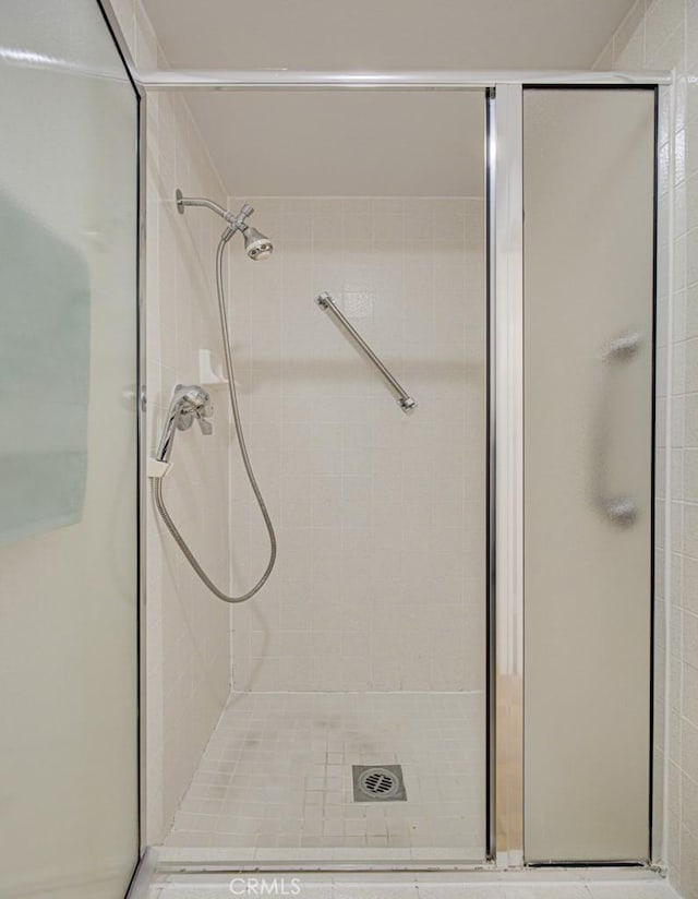 bathroom with a shower with door