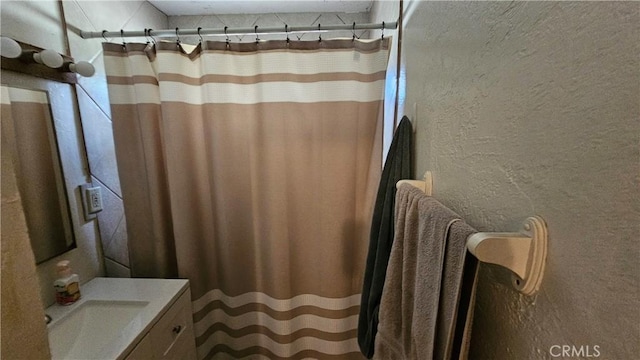 bathroom with vanity and curtained shower