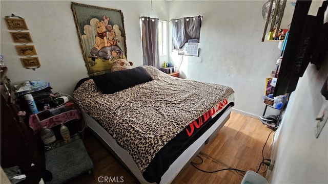 bedroom with hardwood / wood-style floors