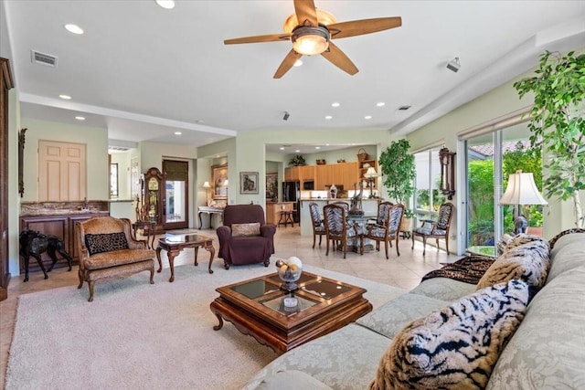 living room with ceiling fan and light tile patterned flooring