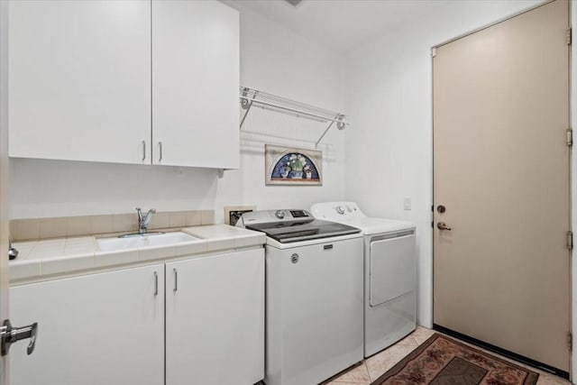 laundry area with cabinets, independent washer and dryer, and sink