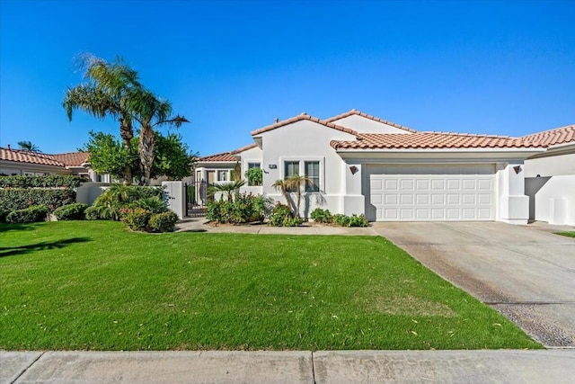 mediterranean / spanish house featuring a front lawn and a garage