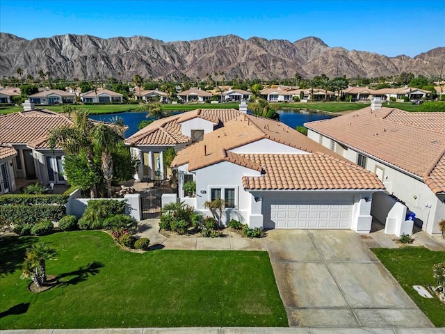 birds eye view of property featuring a water and mountain view