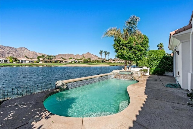 view of pool featuring an in ground hot tub, a patio area, and a water and mountain view