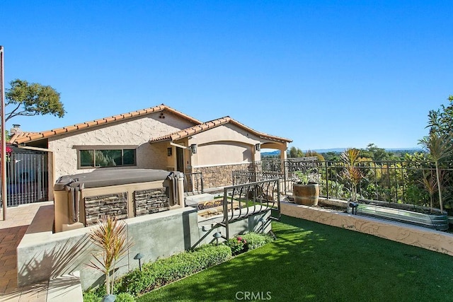 rear view of house featuring a yard