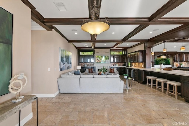 living room featuring beamed ceiling, crown molding, and coffered ceiling