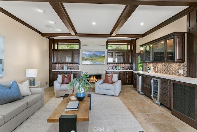 living room with bar area, wine cooler, beam ceiling, and ornamental molding