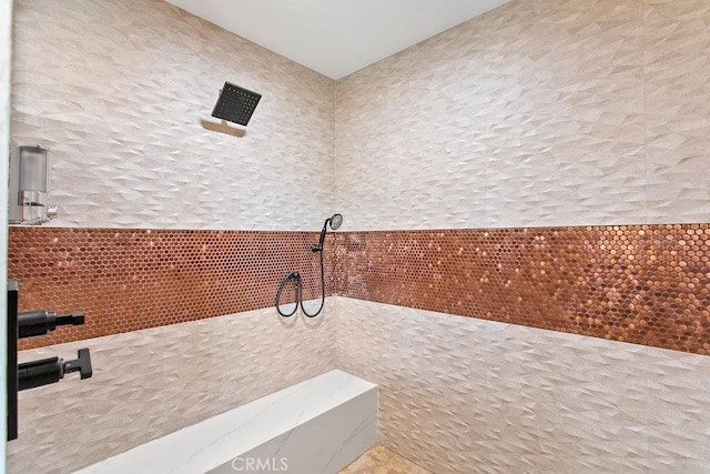 bathroom with tile walls and walk in shower