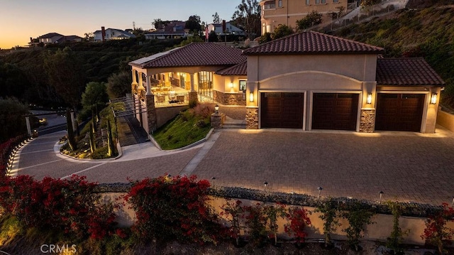 mediterranean / spanish-style home featuring a garage