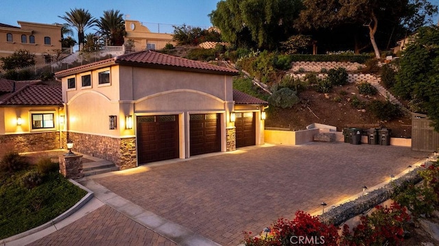 mediterranean / spanish-style home featuring a garage