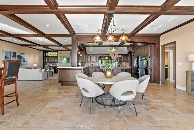 dining space featuring beam ceiling, a chandelier, coffered ceiling, and ornamental molding