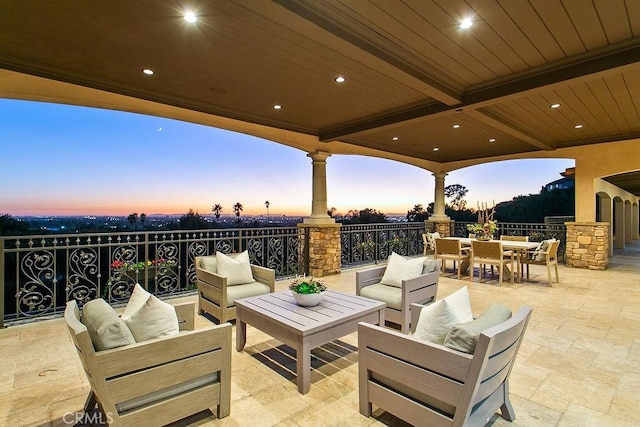 patio terrace at dusk featuring outdoor lounge area