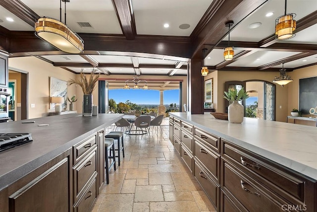 kitchen featuring dark brown cabinetry, beamed ceiling, pendant lighting, and coffered ceiling