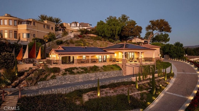 back house at dusk with solar panels