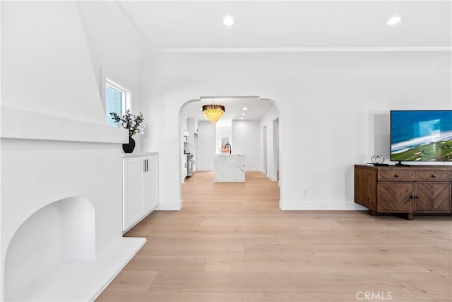 hall featuring light hardwood / wood-style floors and a notable chandelier