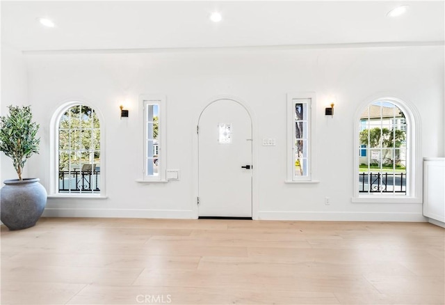 entrance foyer with light wood-type flooring and a wealth of natural light