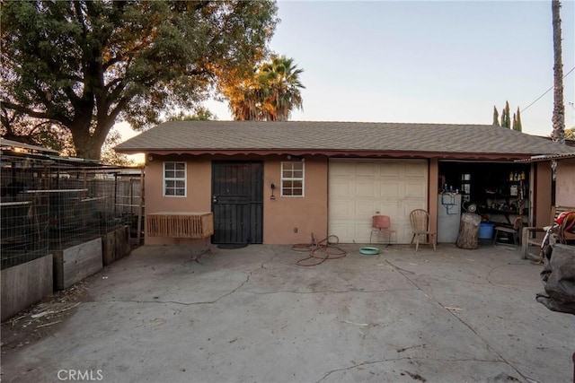 view of garage at dusk