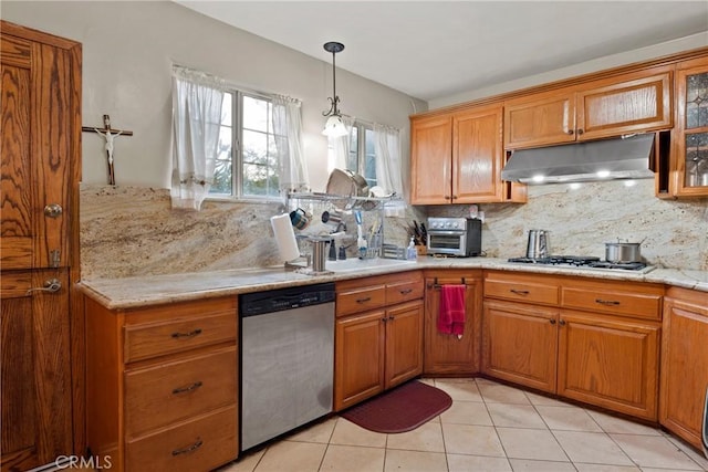 kitchen with light tile patterned flooring, stainless steel appliances, tasteful backsplash, and sink