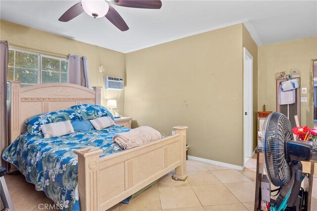 bedroom featuring a wall unit AC, ceiling fan, and light tile patterned floors