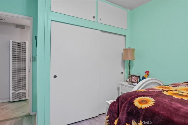 bedroom featuring a closet and light hardwood / wood-style flooring