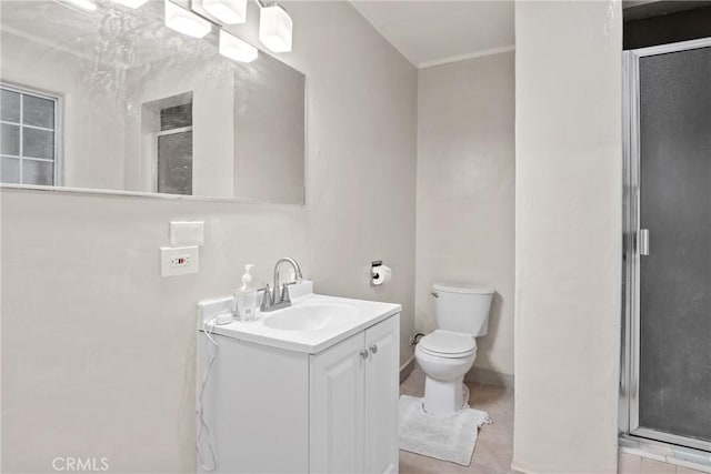 bathroom featuring tile patterned floors, vanity, an enclosed shower, and toilet