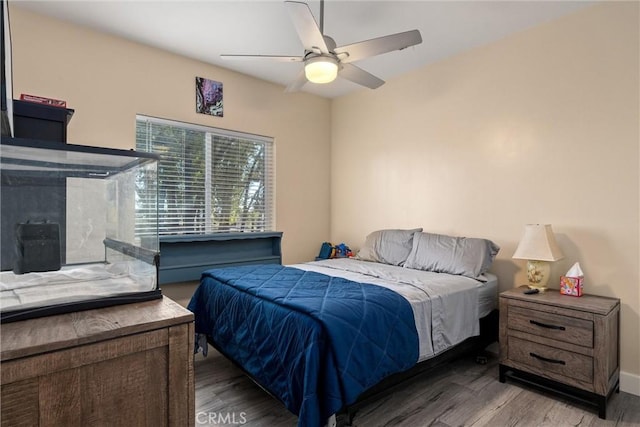 bedroom with ceiling fan and wood-type flooring