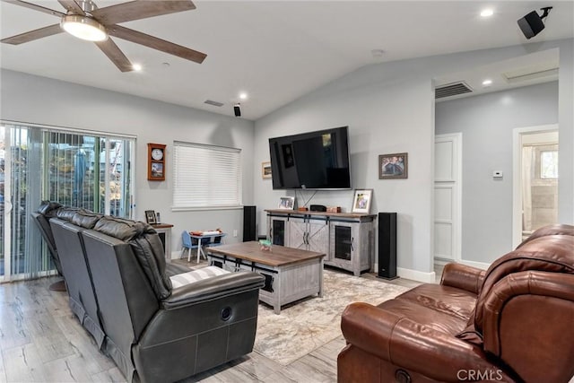 living room featuring ceiling fan, light wood-type flooring, and vaulted ceiling