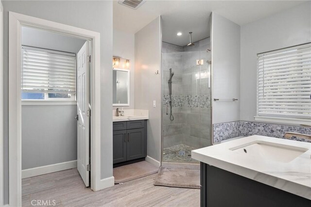 1486 Magadon Rd, Paradise, CA 95969 - bathroom featuring a shower stall, two vanities, and wood finished floors