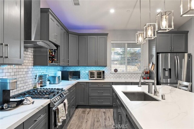 1486 Magadon Rd, Paradise, CA 95969 - kitchen with stainless steel appliances, gray cabinetry, wall chimney exhaust hood, and light stone counters