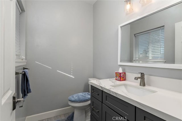 bathroom featuring vanity and toilet