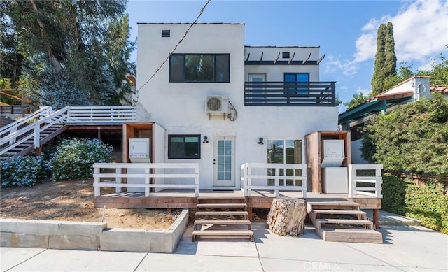 view of front of property with a balcony and a wooden deck