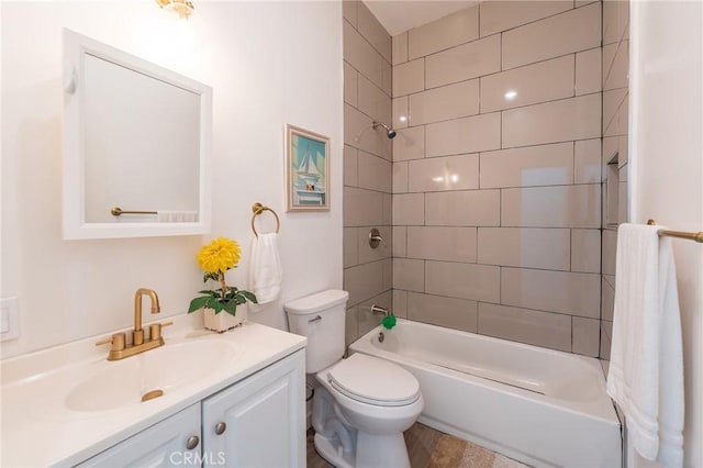 full bathroom with toilet, vanity, and tiled shower / bath combo