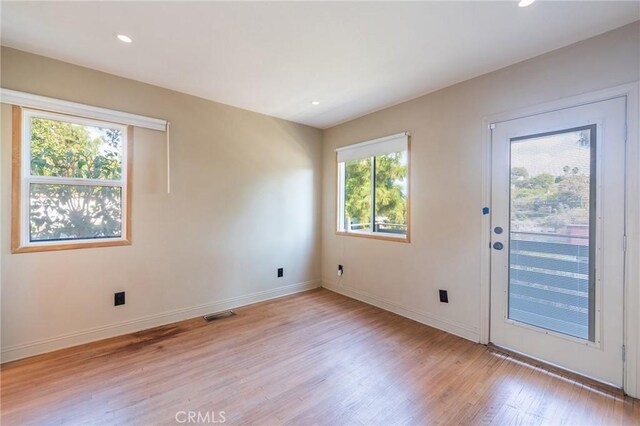 doorway to outside with light wood-type flooring