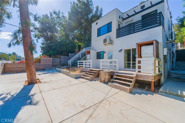 back of house with a balcony and a patio area