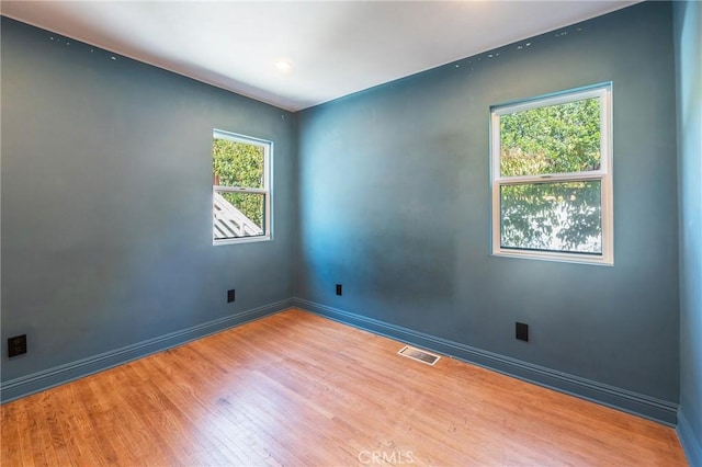 unfurnished room featuring light hardwood / wood-style flooring