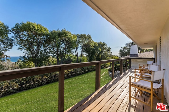 wooden terrace featuring a yard