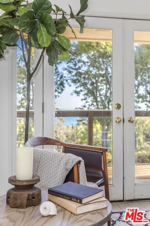 sunroom / solarium featuring french doors