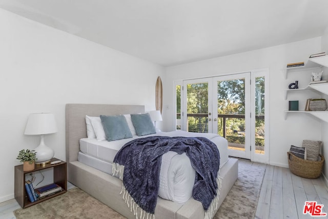 bedroom with french doors, access to outside, and light hardwood / wood-style flooring